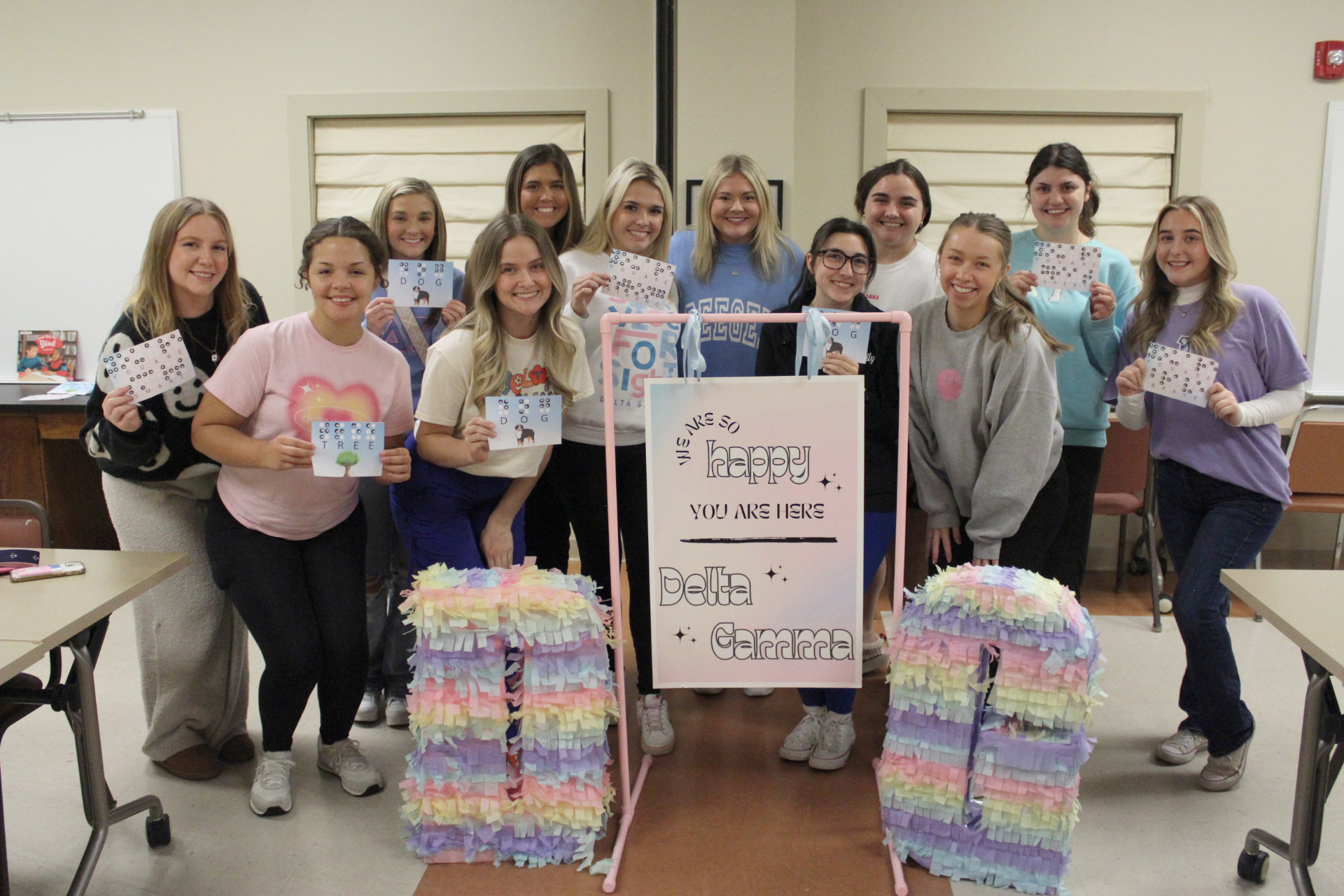Delta Gamma members posing with braille program supplies