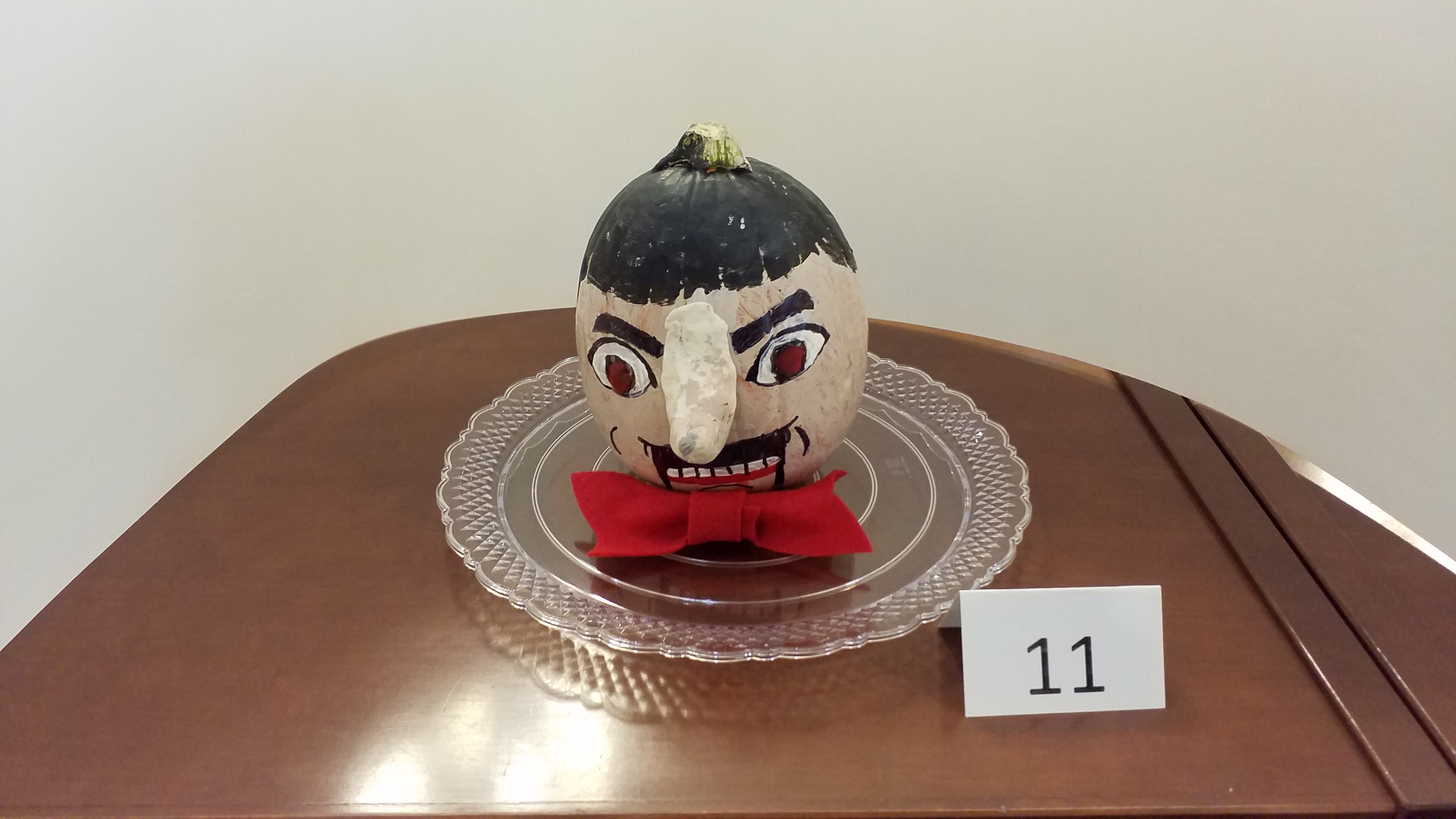 Pumpkin decorated as haunted ventriloquist dummy