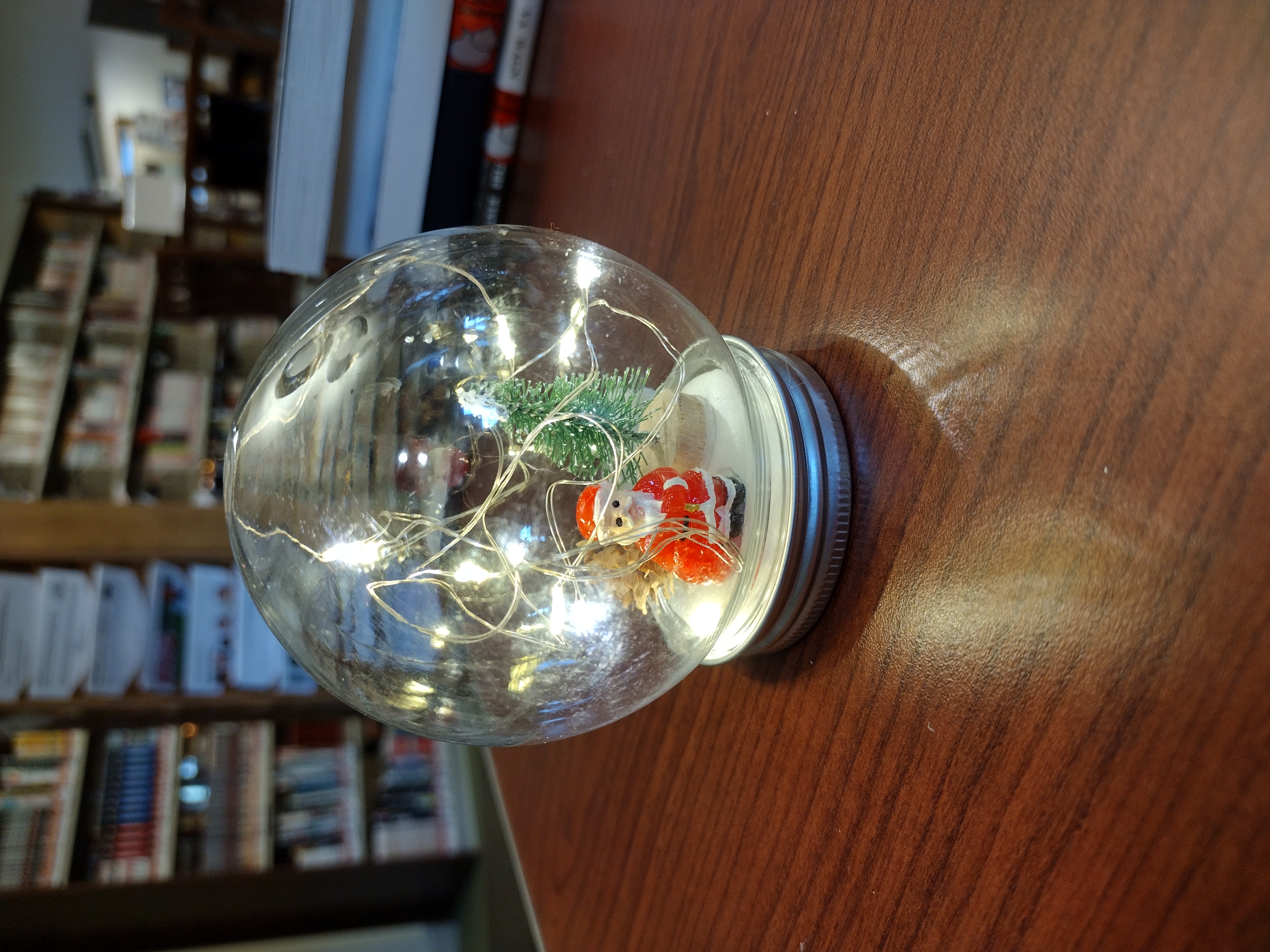 Snowglobe craft with miniature Santa Claus and fairy lights inside