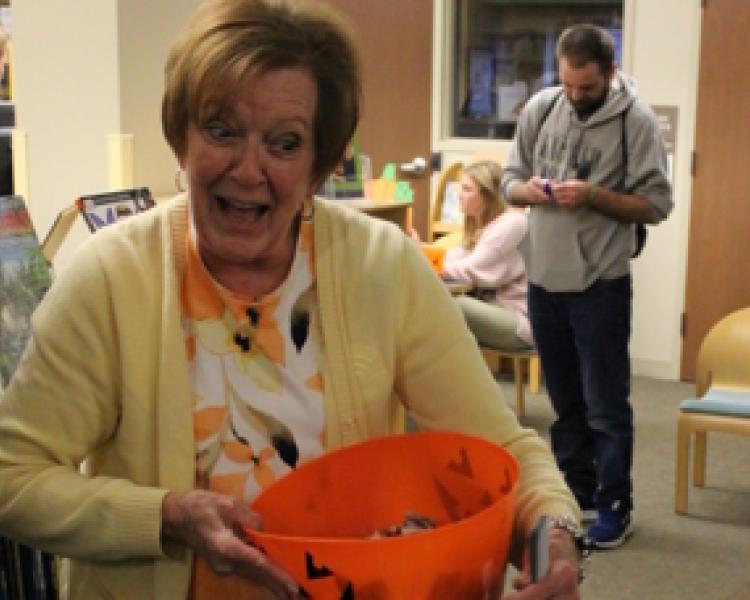 Children's Librarian Sandy with a bowl of Halloween candy